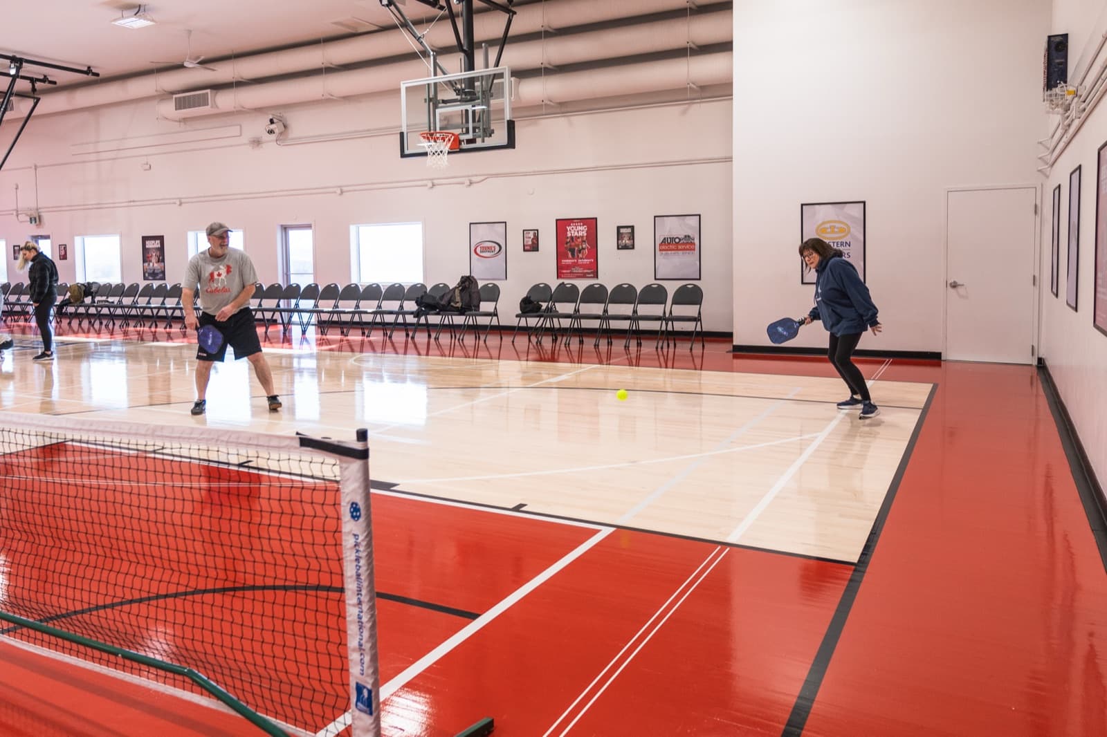 Two Prairie Pickleball members playing on their own half of the court in Regina