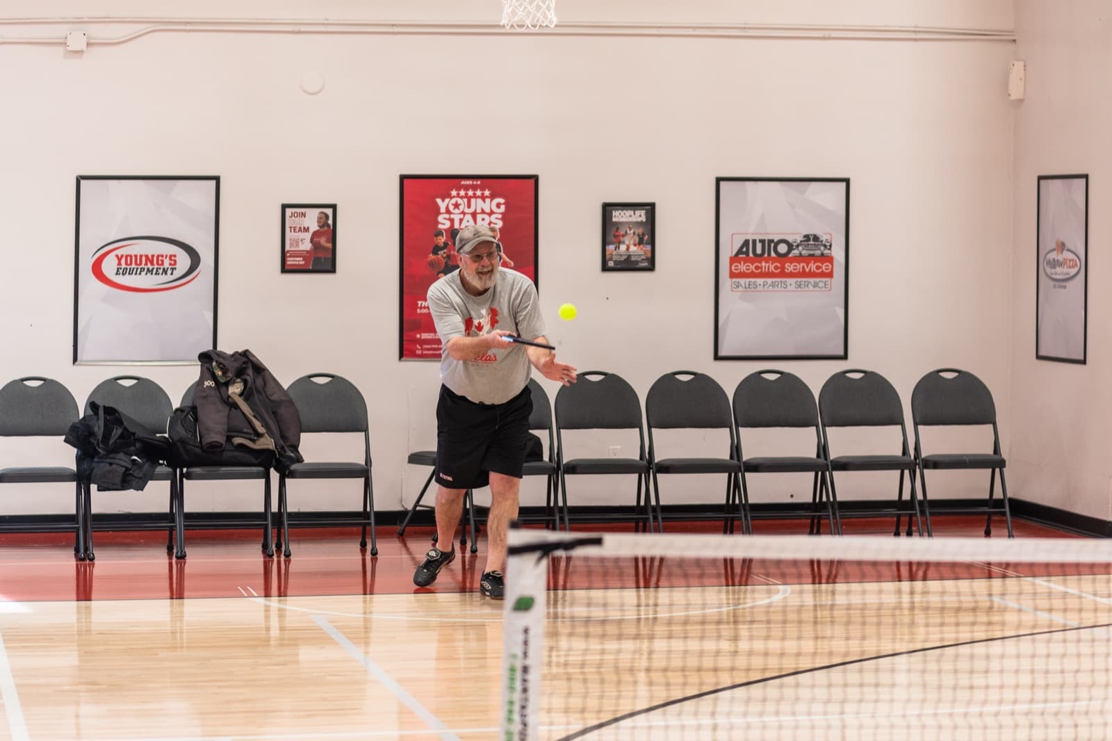 A Prairie Pickleball member hitting the ball across the net in Regina